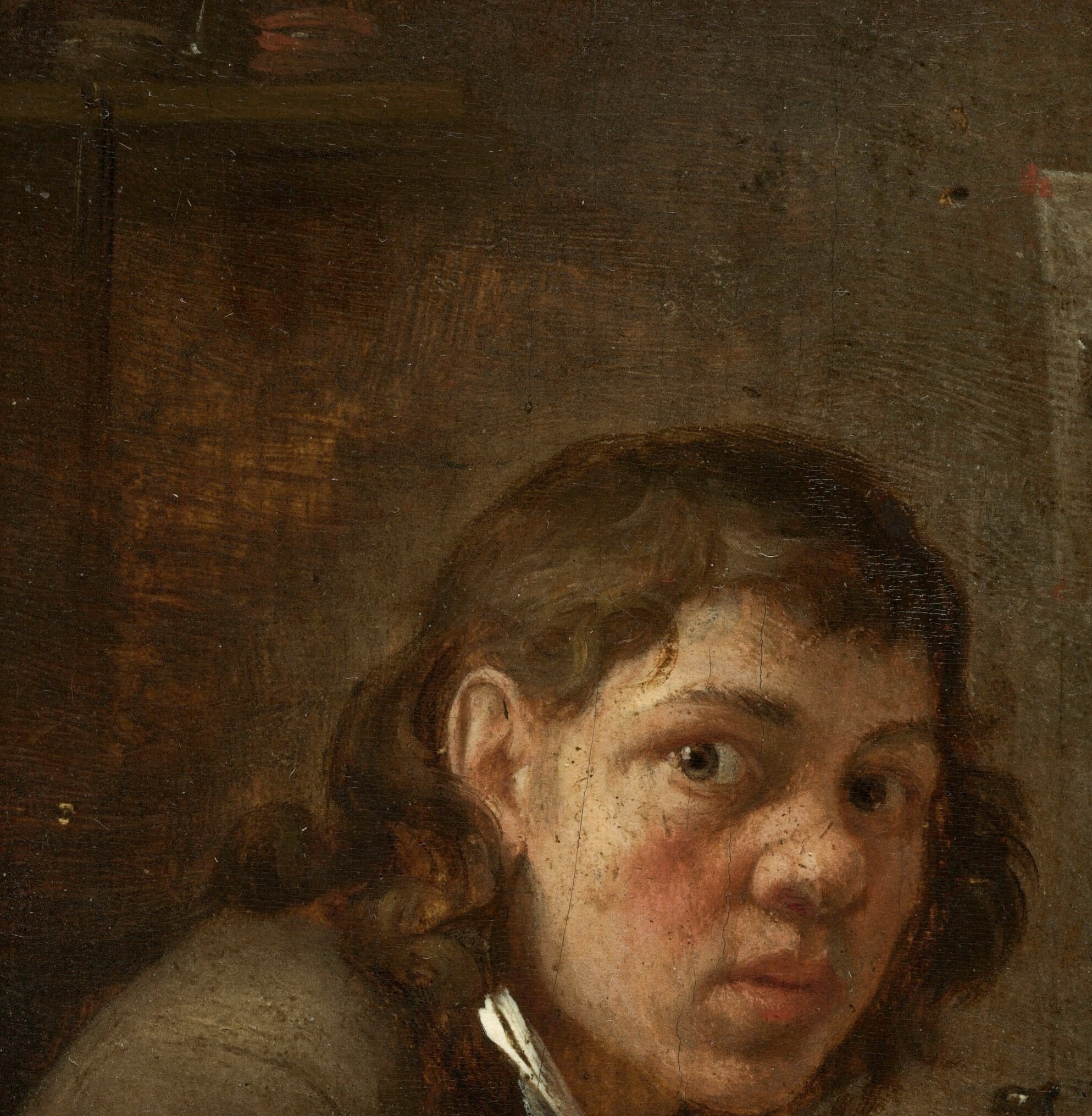 He looks straight at you. He's maybe fifteen.