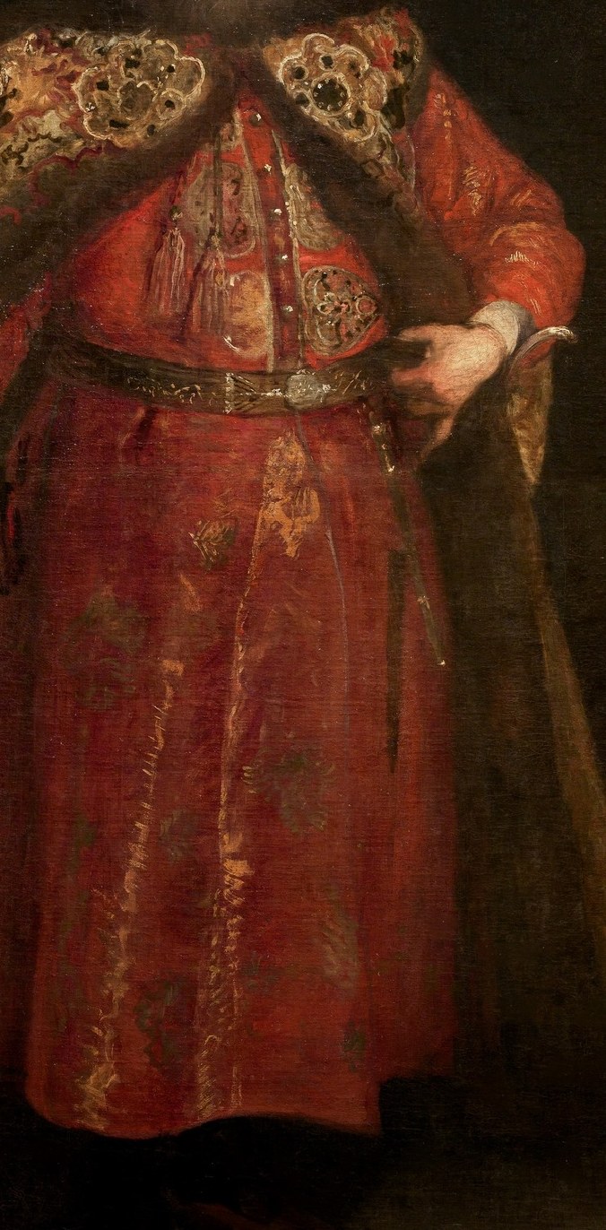 His ornate robe sparkles with gold.