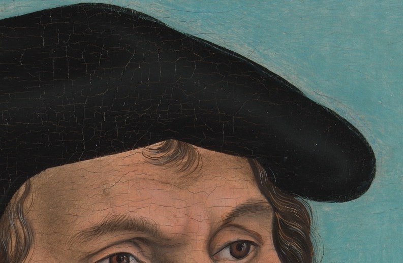 The soft texture and slight sheen of the fabric are rendered with skill, framing his face.