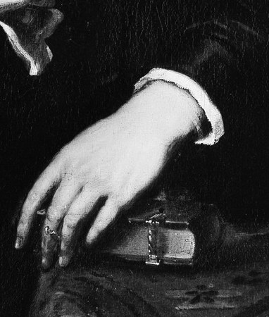 The visible ring on her finger is a subtle indicator of marital status or wealth.