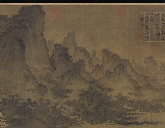 Mountains built up in layered peaks, receding into mist.