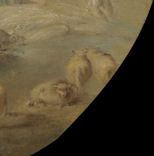 A shepherd watches his flock rest.