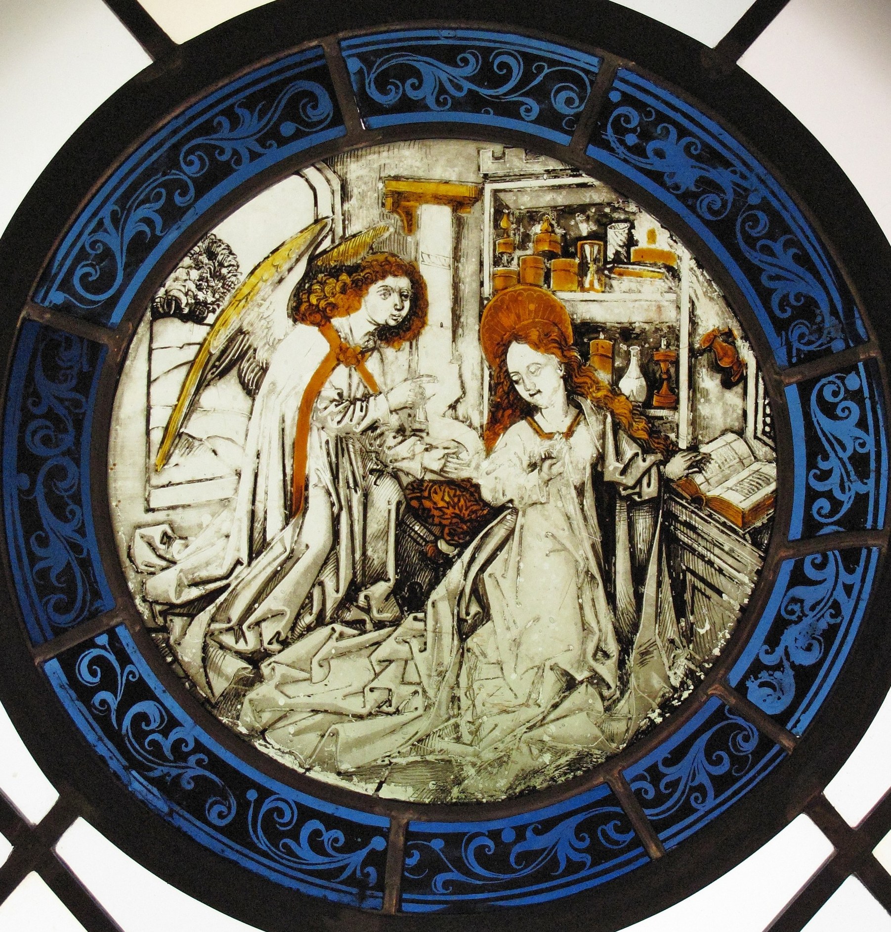 The network of lead dividers is part of the object's identity as stained glass, not a flaw , it reveals how the image was pieced together from multiple fired glass sections.