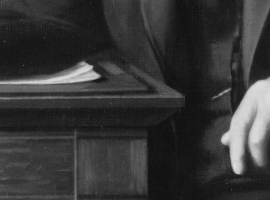 A pen in his right hand, papers on the desk. An empire rests on his signature.