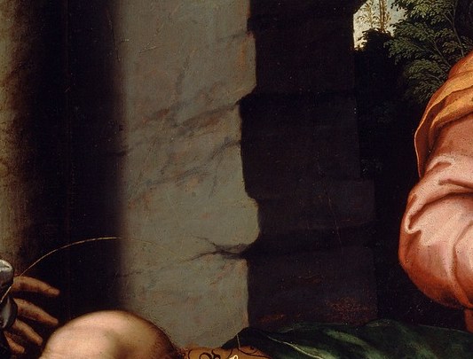 His gaze is directed downwards, suggesting innocence and vulnerability, a focal point of the scene.