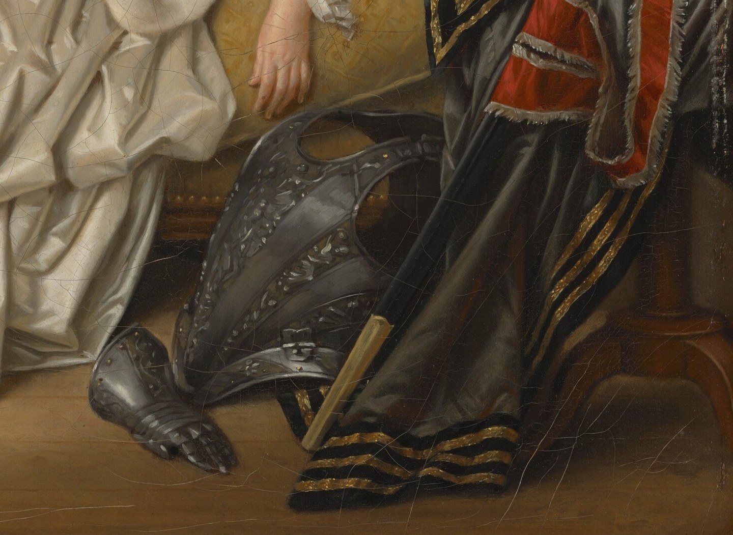Pieces of armor lie discarded near her on the floor.