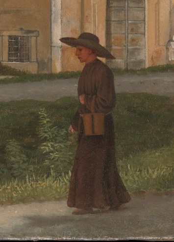 A monk walks past the stone debris.