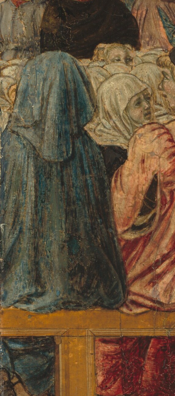 His deep blue hood creates a strong visual anchor on the left, drawing the eye into the dense gathering.