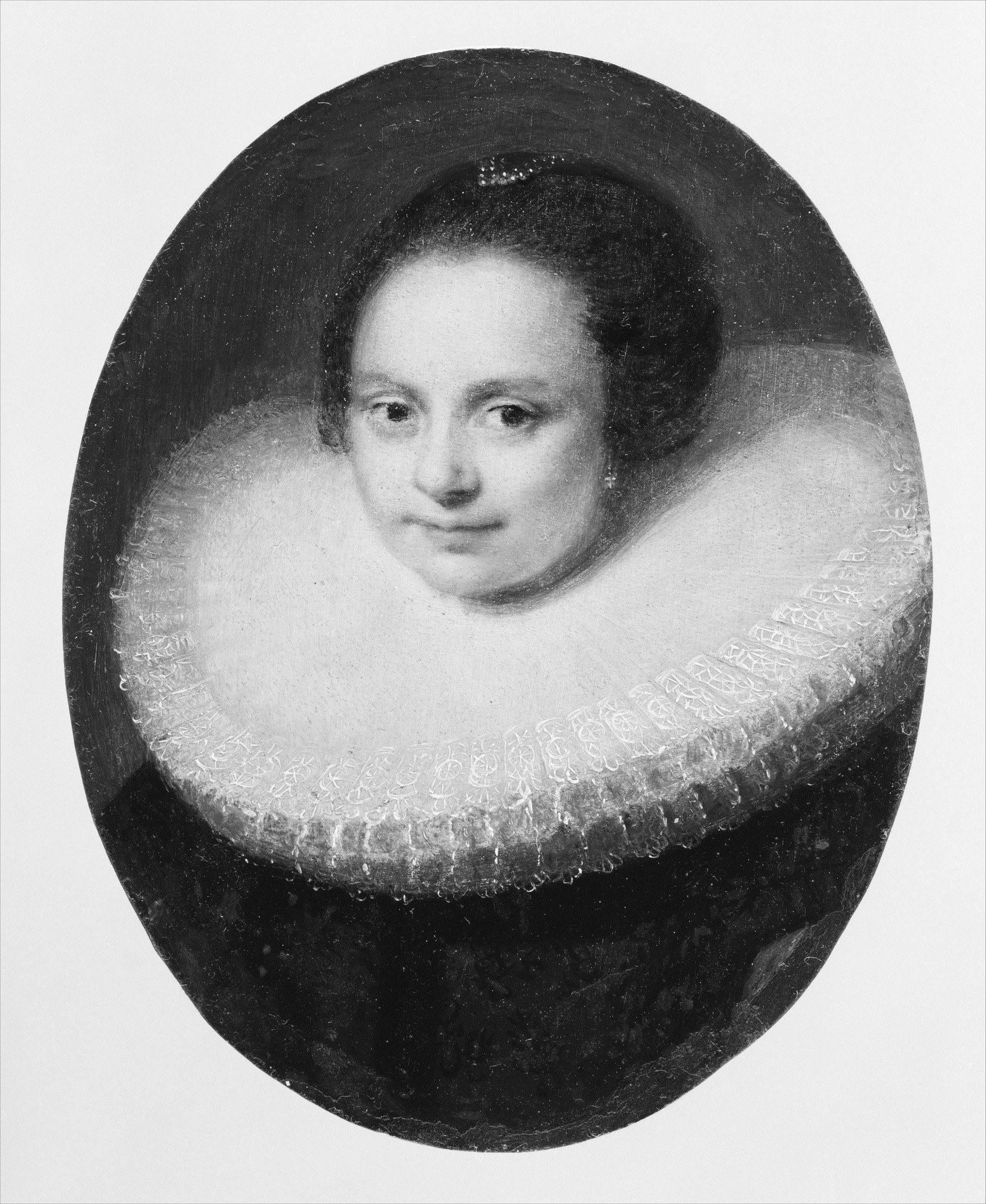 The deep, uniform background isolates the sitter, drawing all attention to her presence and expression.