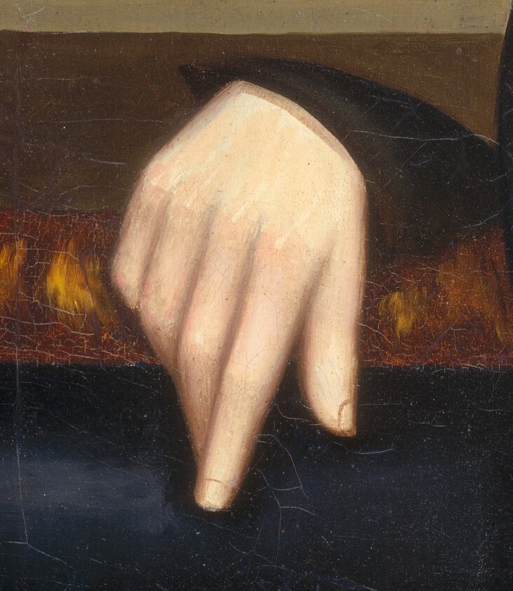 The relaxed pose of the hand suggests ease and familiarity with his surroundings.
