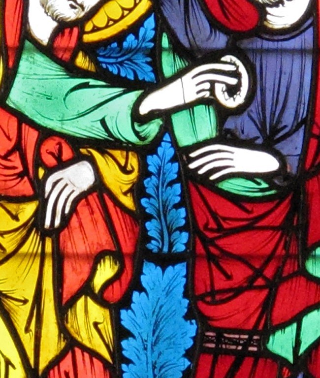 Now look at the center. A hand touches an open wound.
