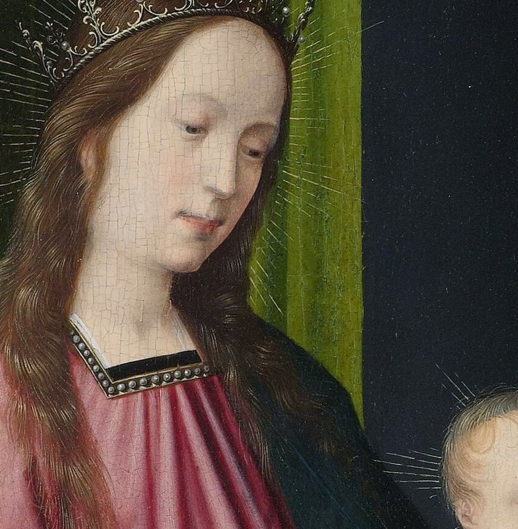 Her gentle gaze and slightly downcast eyes convey maternal tenderness and a sense of introspection.