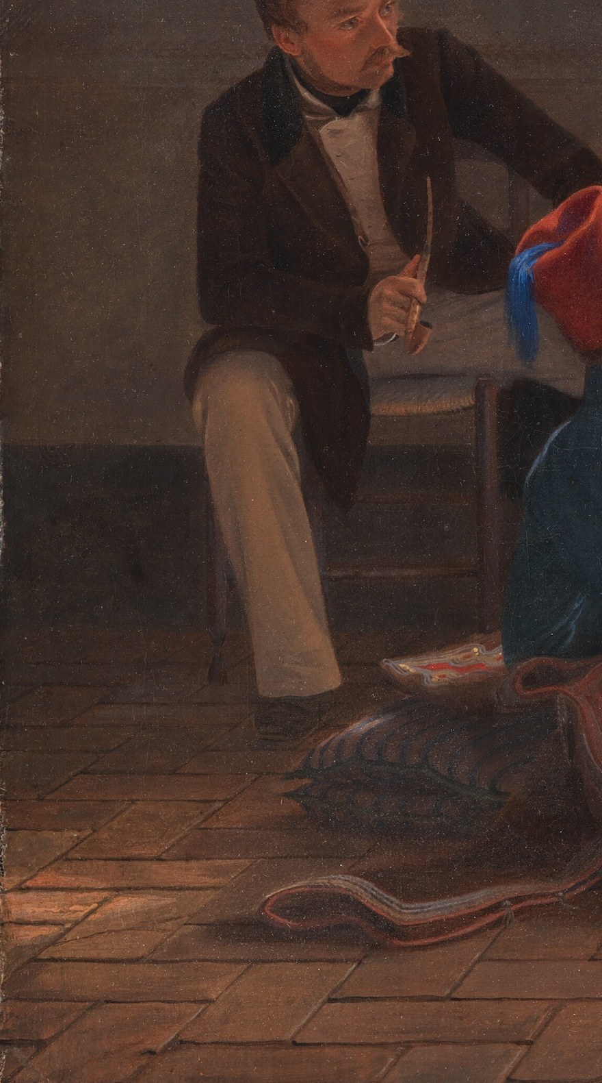 The painter himself sits on the floor, holding his portfolio.