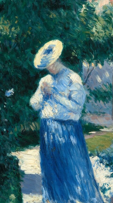 In the bright light, a woman pauses on the path.