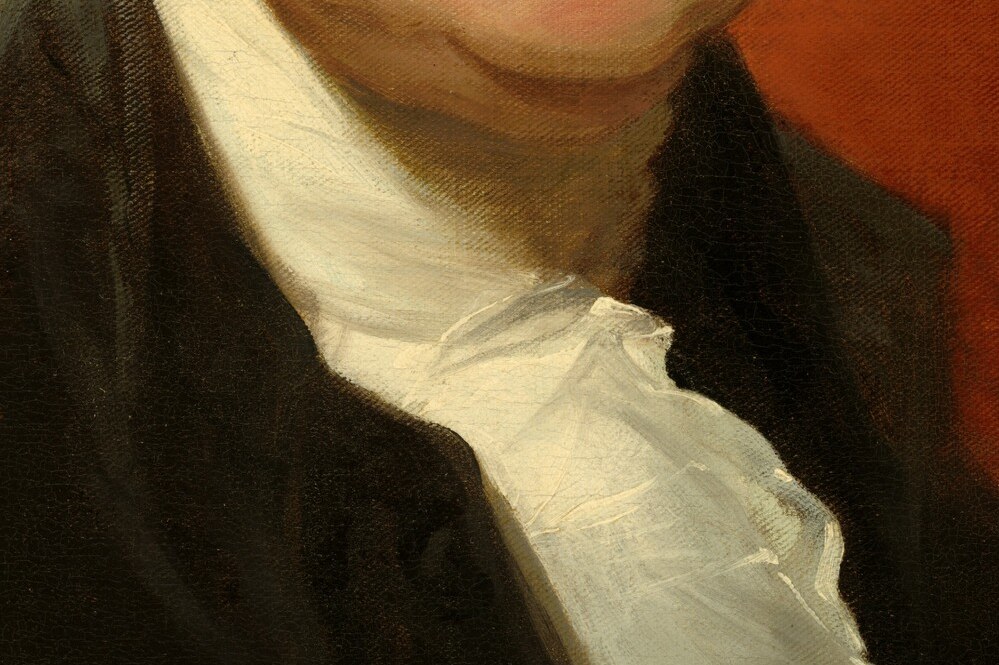 His mouth is pressed tight, pushed forward by ill-fitting dentures.