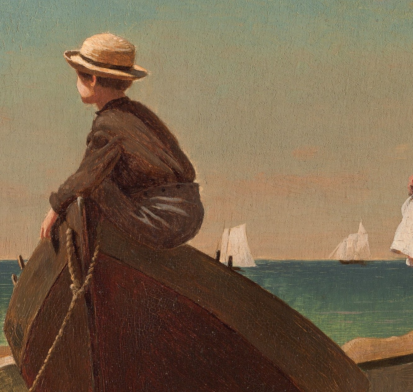 A boy in a boat looks out to sea, too.