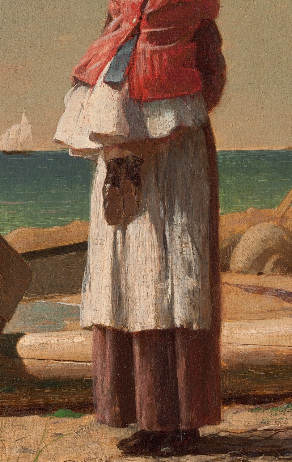A woman and child wait on the shore.