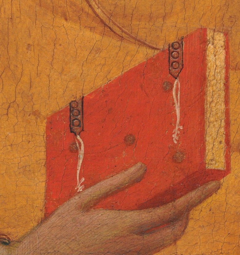 He preaches the gospels, holding the sacred book.