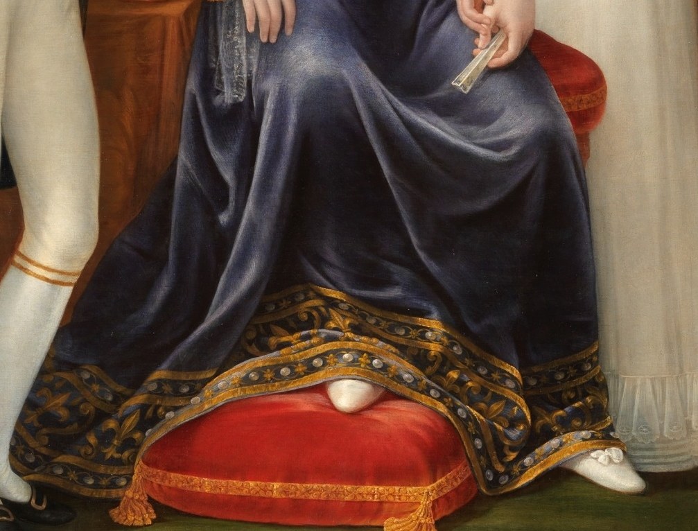 Her velvet robe signifies immense wealth.