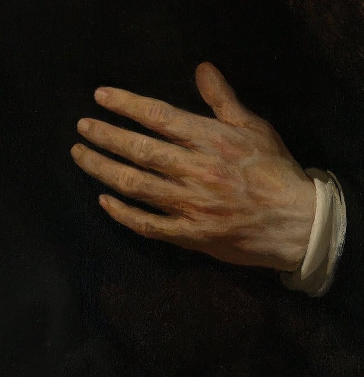 His right hand rests over his heart, a common gesture.