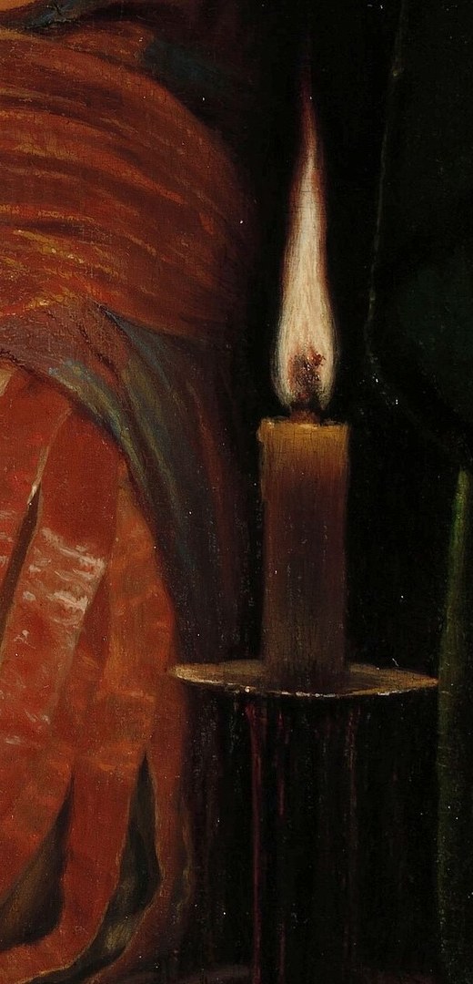 The single candle highlights her intense concentration.