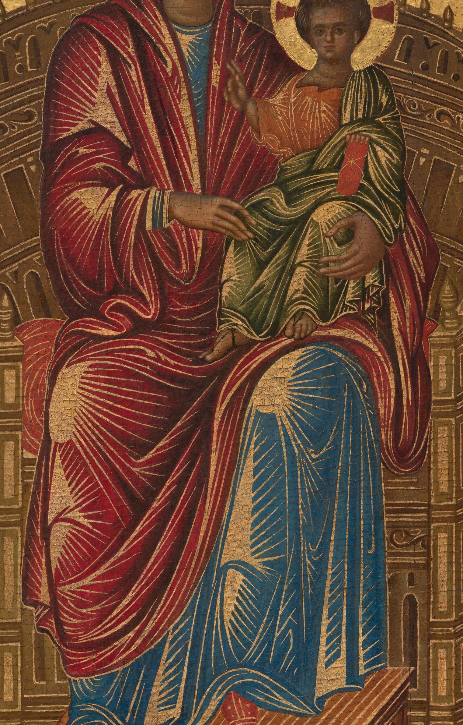 The rich red fabric, with its radiating gold lines, signifies her status as Queen of Heaven and her divine passion.