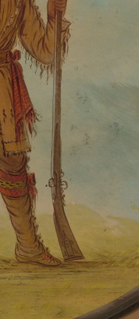 The spear holds tradition. The rifle holds the new reality.