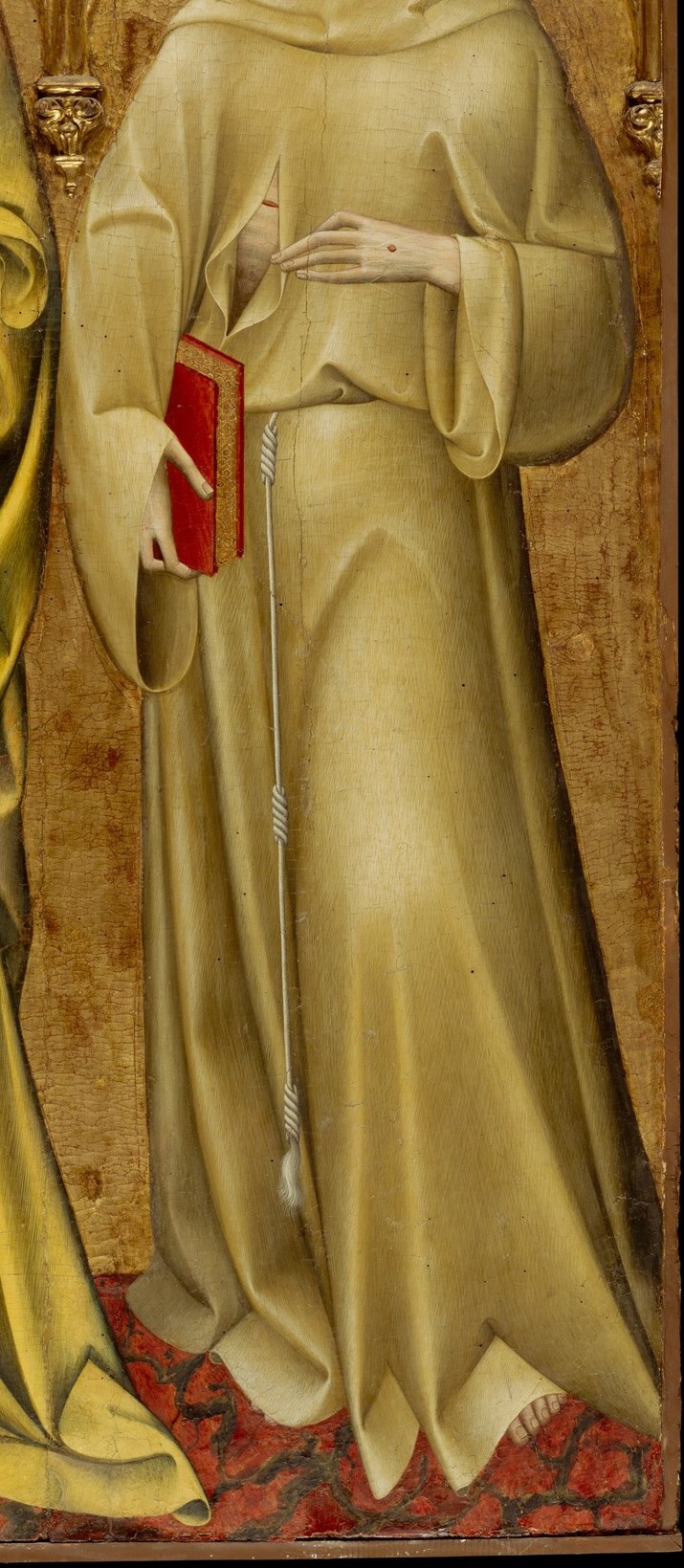 On the right, Saint Francis wears the humble habit of his monastic order.