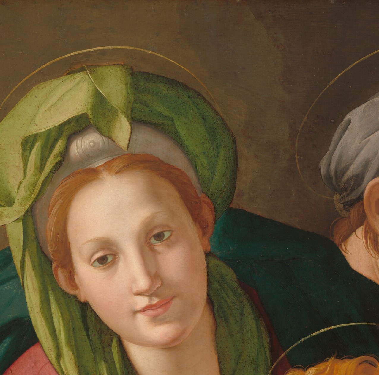 Serene, idealized Mannerist features with downcast eyes; the green veil and soft lighting reveal Bronzino's mastery of cool, porcelain-like flesh tones.