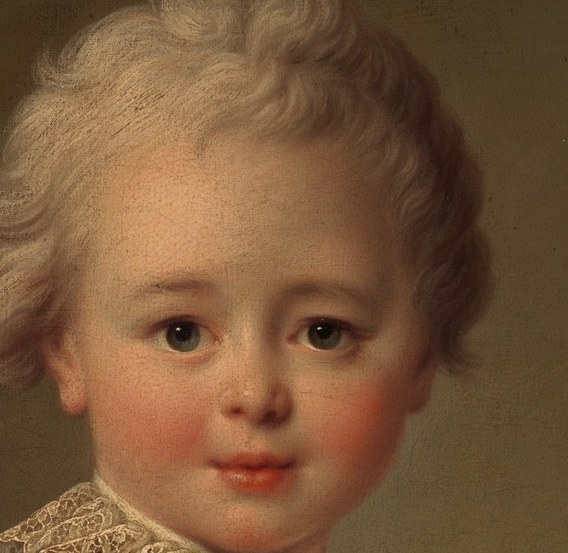 His curly hair and gentle expression speak of innocence.