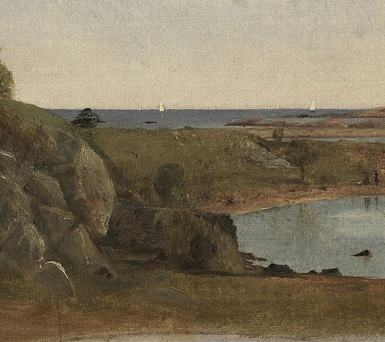 Shows the rugged texture of the coastline and the interplay of light and shadow on stone.