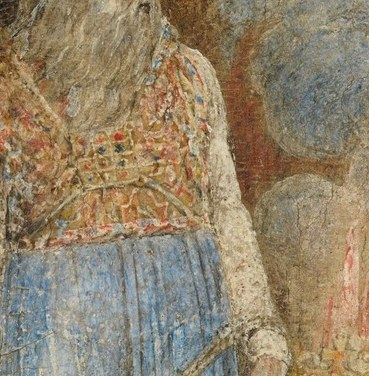 The flowing beard adds to his patriarchal and venerable appearance, emphasizing his status.