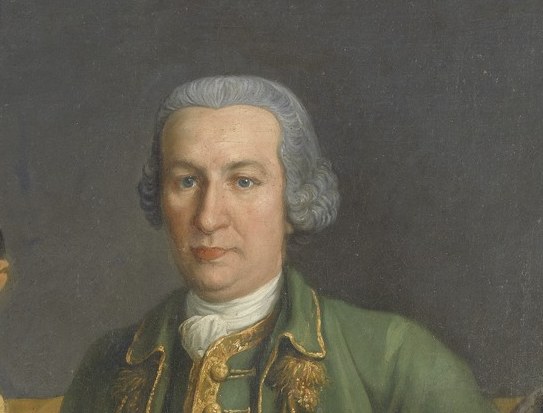 His direct gaze and stern expression suggest authority and perhaps a touch of weariness from his responsibilities.