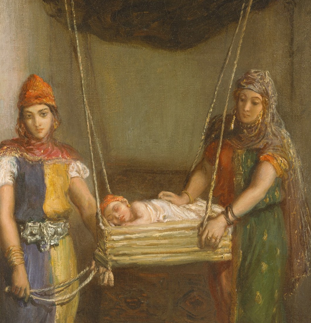 The hanging cradle is a specific North African Jewish domestic tradition; its construction and the tautness of the ropes document a real cultural practice