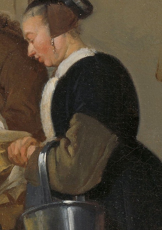 Her posture and gaze suggest a collaborative or instructive relationship with the tailor.