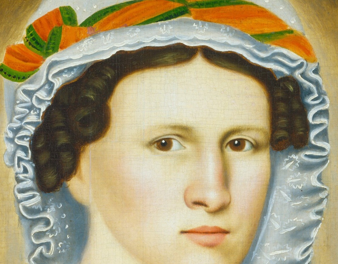 Her bonnet has a bright orange ribbon, a splash of color.
