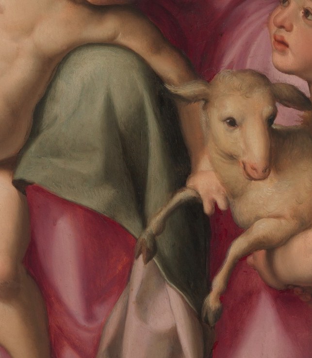 The central theological object , Agnus Dei, emblem of Christ's future sacrifice; its pale wool glows against the blue drapery as a visual anchor.