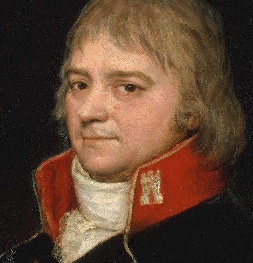 His direct gaze and slightly parted lips suggest a moment of contemplation or quiet authority.