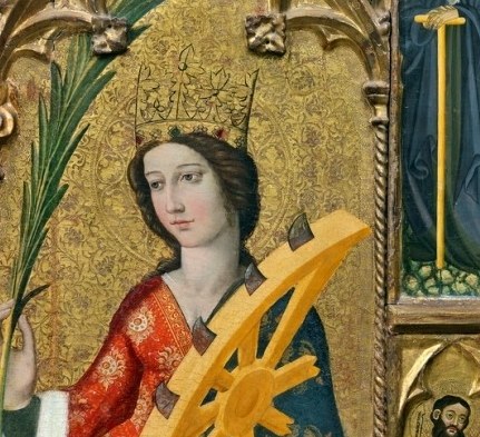 Saint Catherine stands here, known for her sharp intellect.