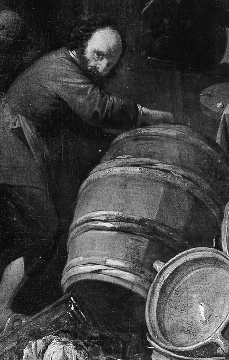 A man is absorbed in work, surrounded by humble objects.