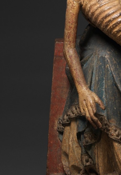 His dead arm drops straight down. In this period, that is a hard sign of lifelessness.
