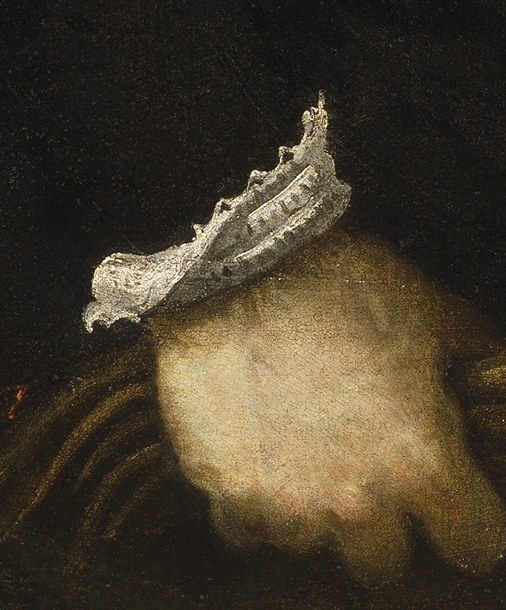 Look closely at his refined attire, like the intricate lace cuff.