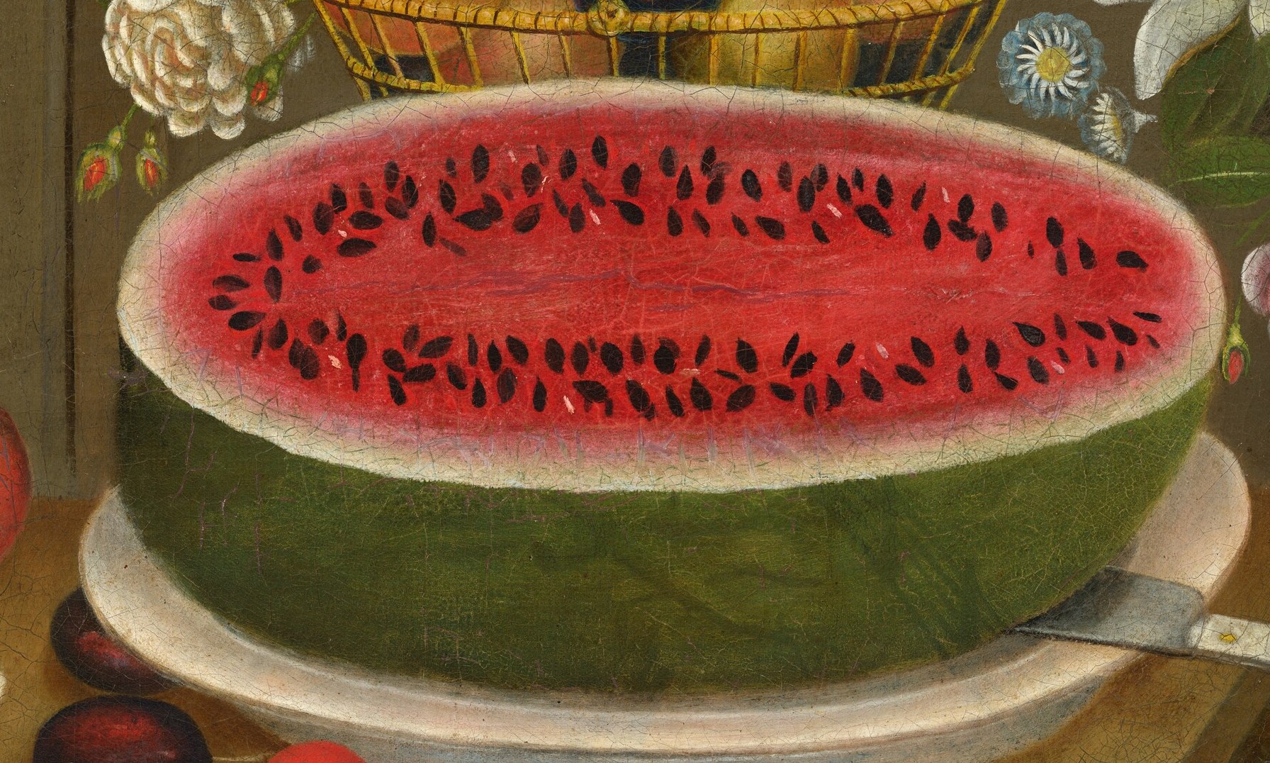 The watermelon is sliced open, its flesh glistening and precise.