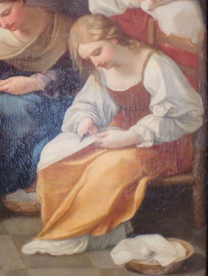 Here, one woman works a needle and thread.