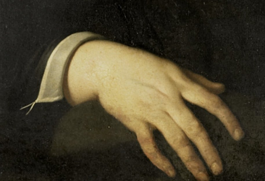 His open hand suggests a moment of contemplation or repose.