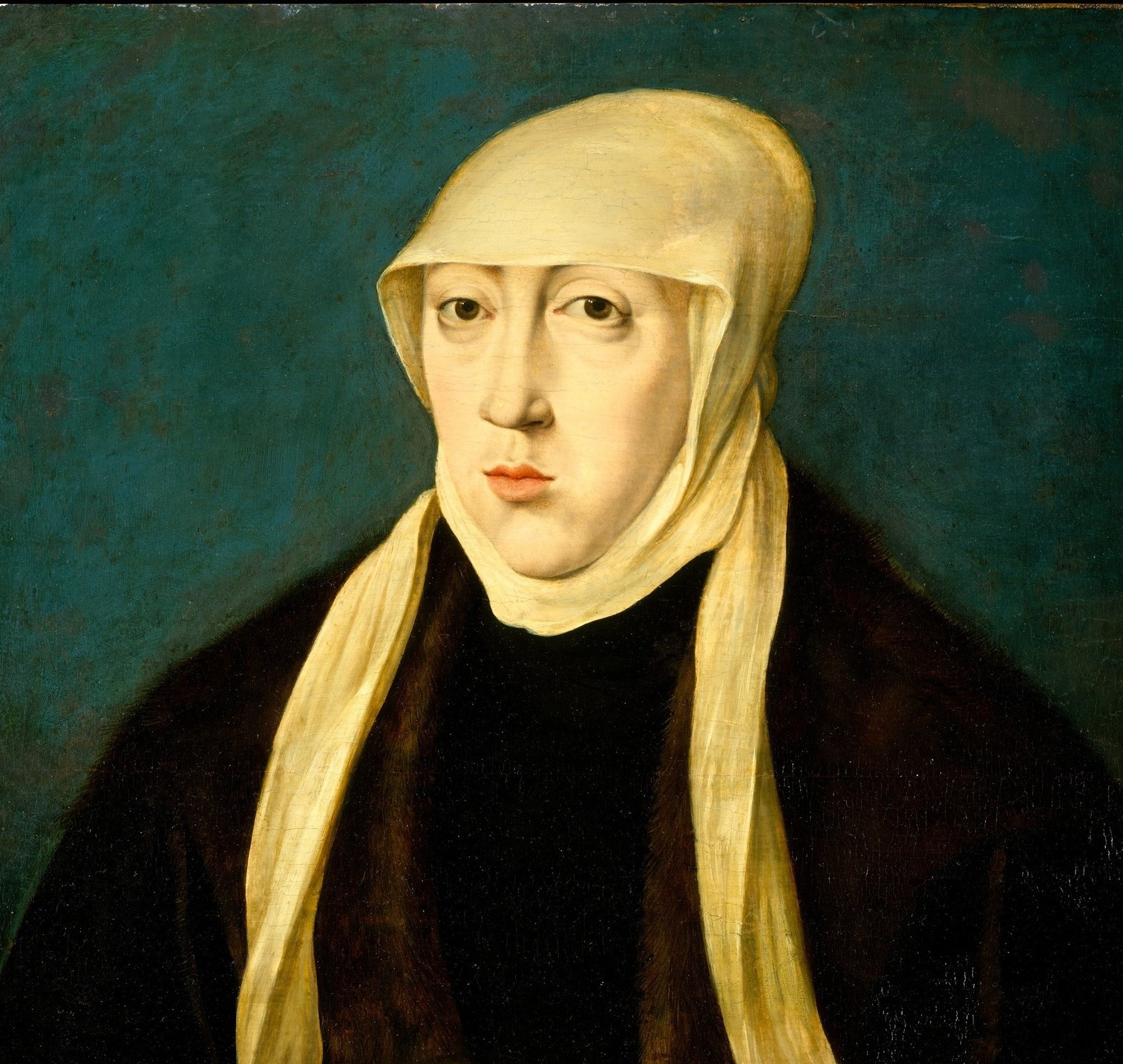 Her white headdress signals decades of mourning.