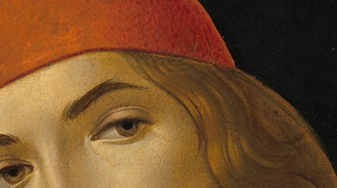 This young man steps out of the dark, holding our gaze.