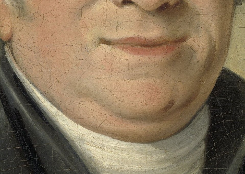 The intricate lace of his collar hints at his status and the fashion of the era.