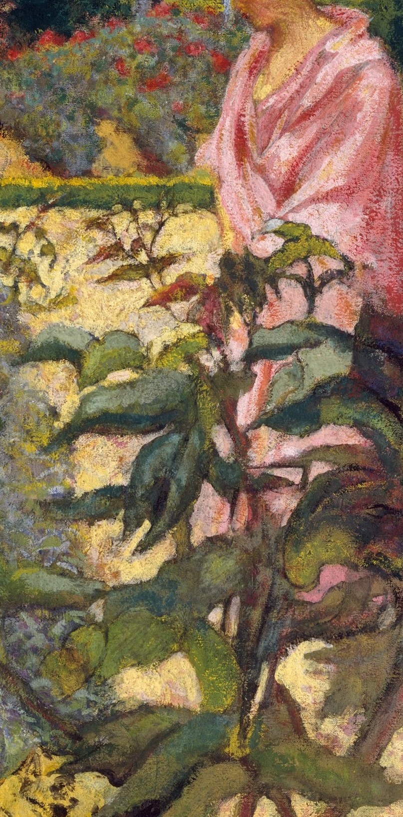 A woman in pink is nearly swallowed by the flowers.