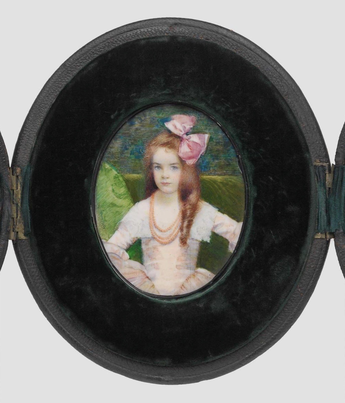 The deep, textured frame encloses the miniature portrait, emphasizing its preciousness and creating a sense of intimacy.